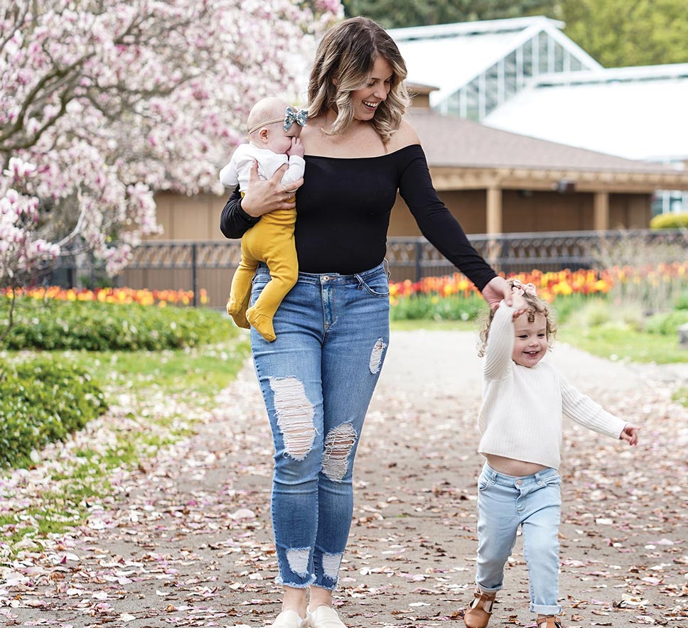 A Mom with her two kids walking through an attraction