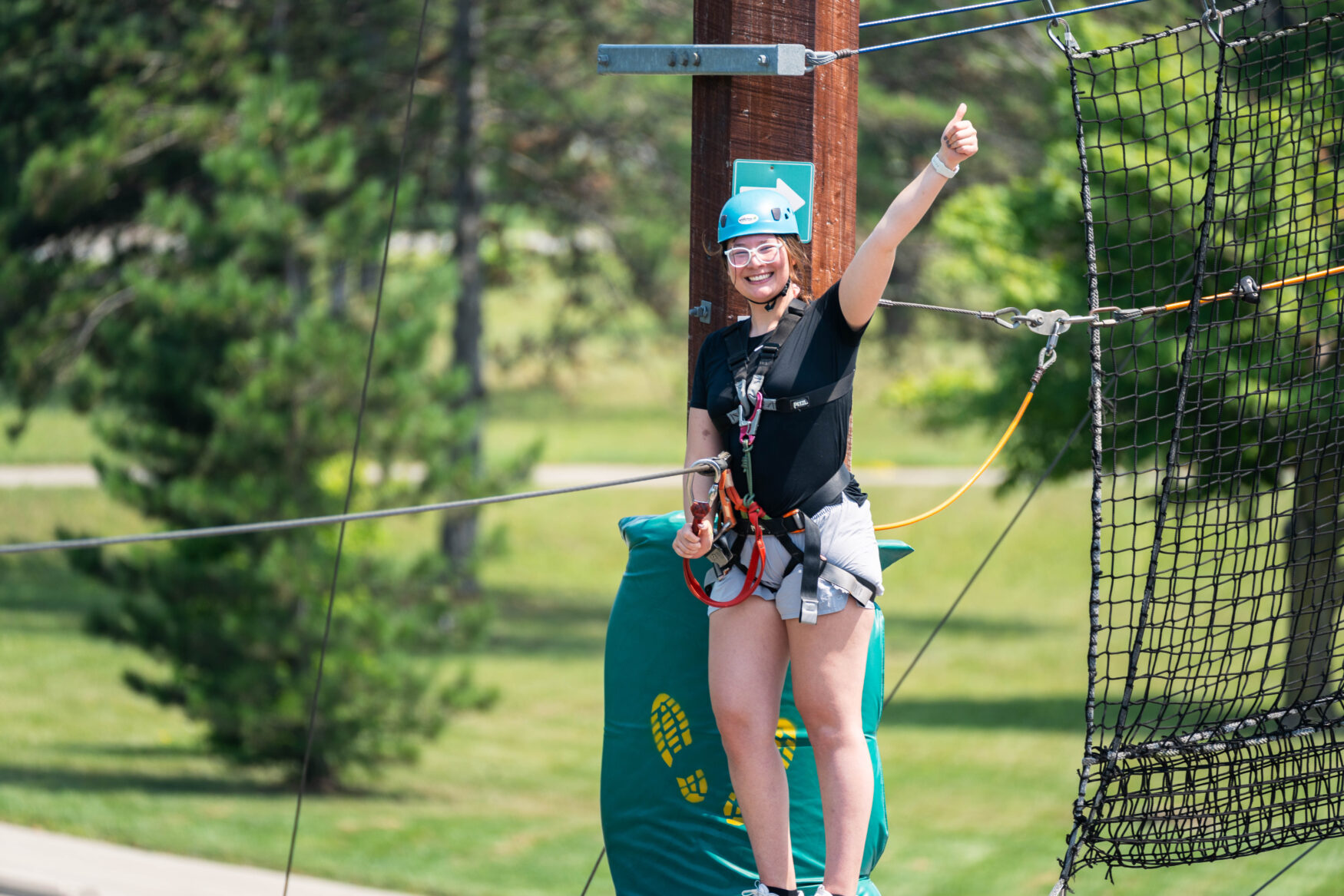 A woman giving a thumbs up after completing the course